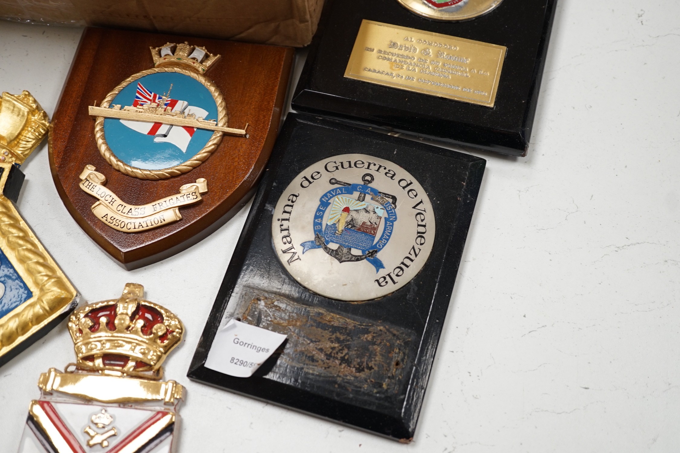 A collection of approximately twenty five plaster and other naval / military and Royal wall hanging plaques